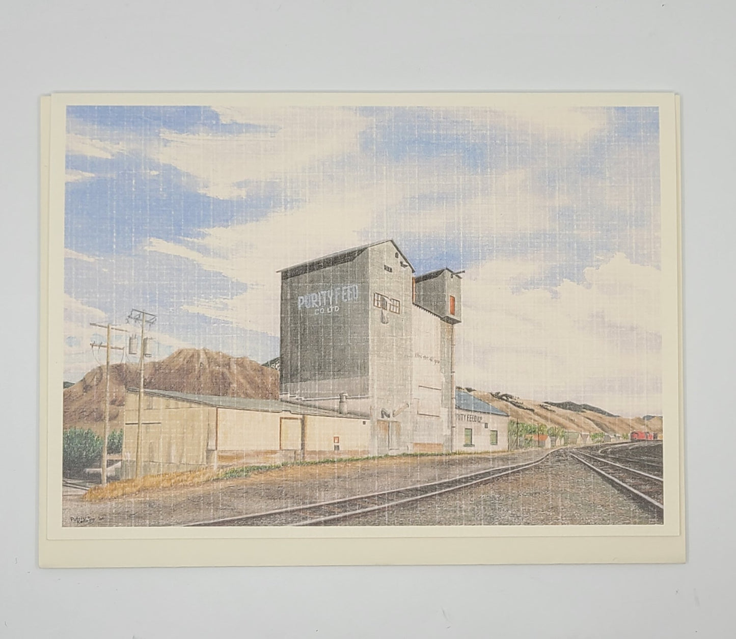 Artistic depiction of a grain elevator with mountains and tracks in the background.