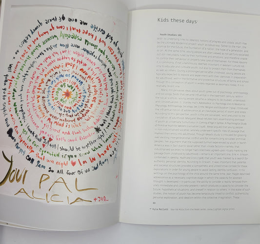 Open book with colorful handwritten text and a page of printed text titled 'Kids these days'.