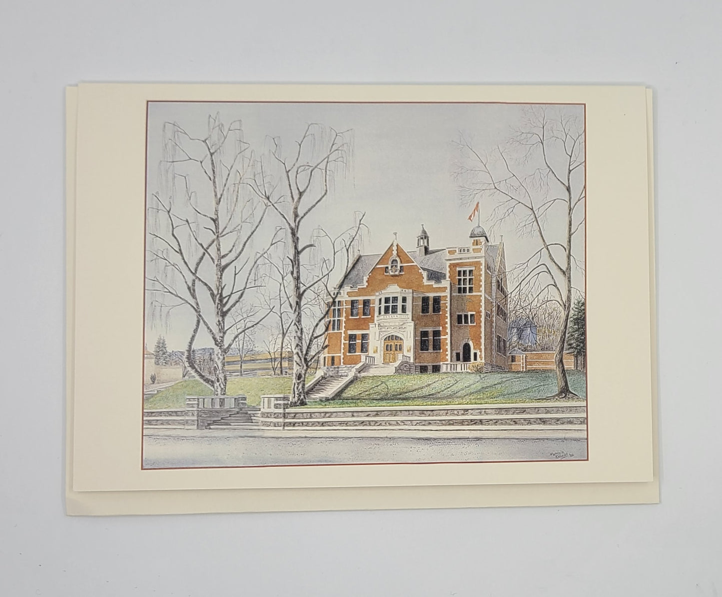 Framed artwork of a ref large bricked building with trees on a gray background