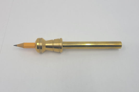 Brass pencil on a white background