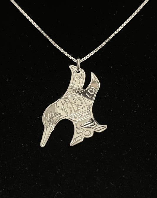 Silver hummingbird-shaped pendant on a black background