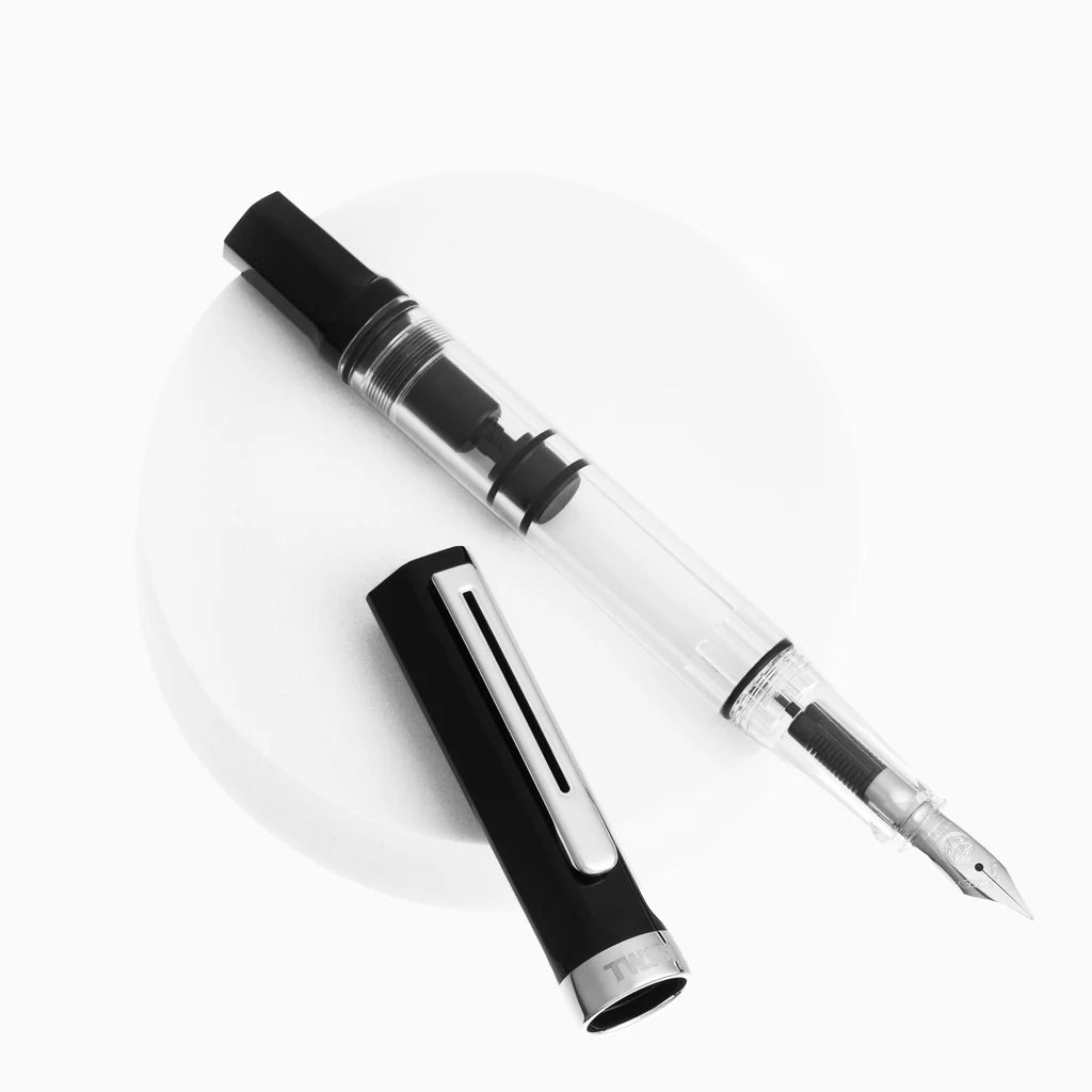 Black and clear fountain pen on a white background