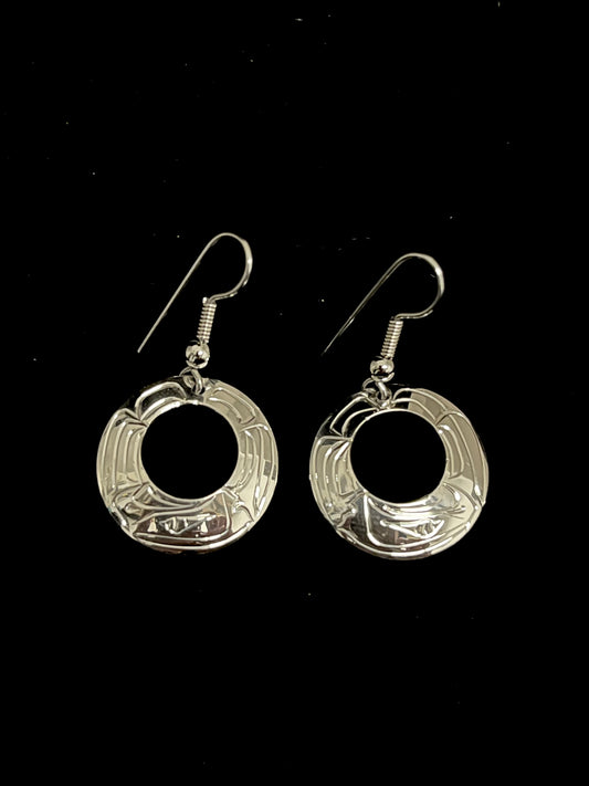 Pair of silver eagle O shaped earrings on a black background