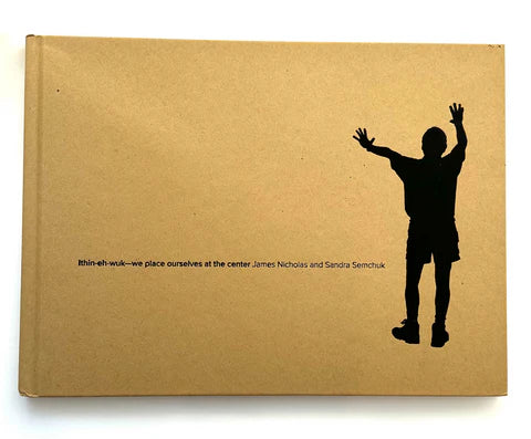 A Tan-ish cardboard book with a black silhouette of man with is hands up and out spread on a white background.
