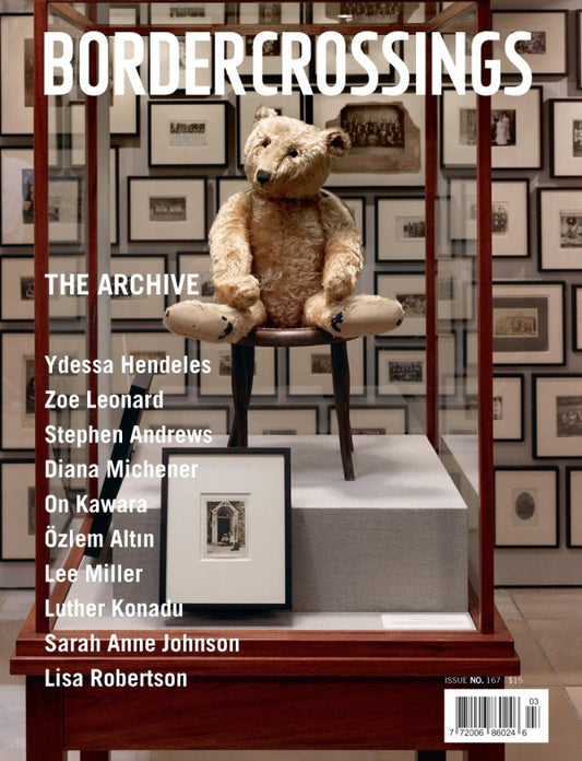 Cover of 'Bordercrossings' magazine with a teddy bear on a chair and framed pictures in the background.