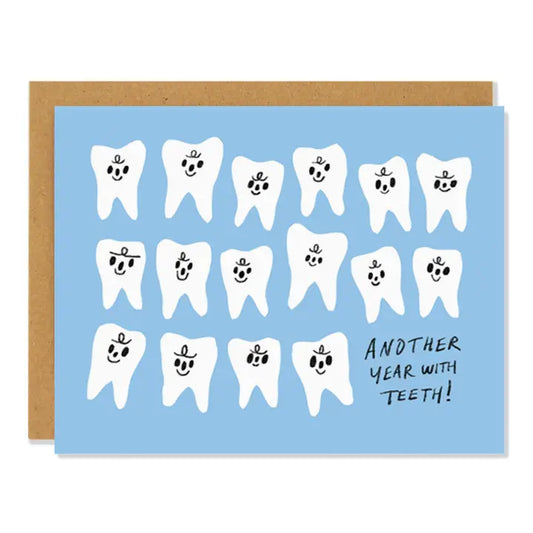 Card with cartoon teeth and text 'Another year with teeth!' on a blue background