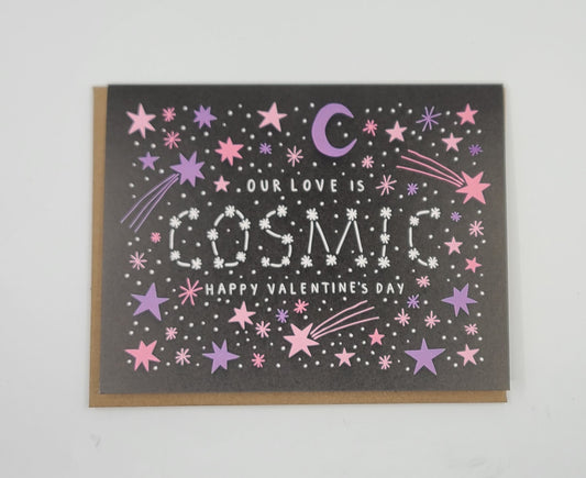 Valentine's Day card stating "Our love is cosmic" with star and moon designs on a black background