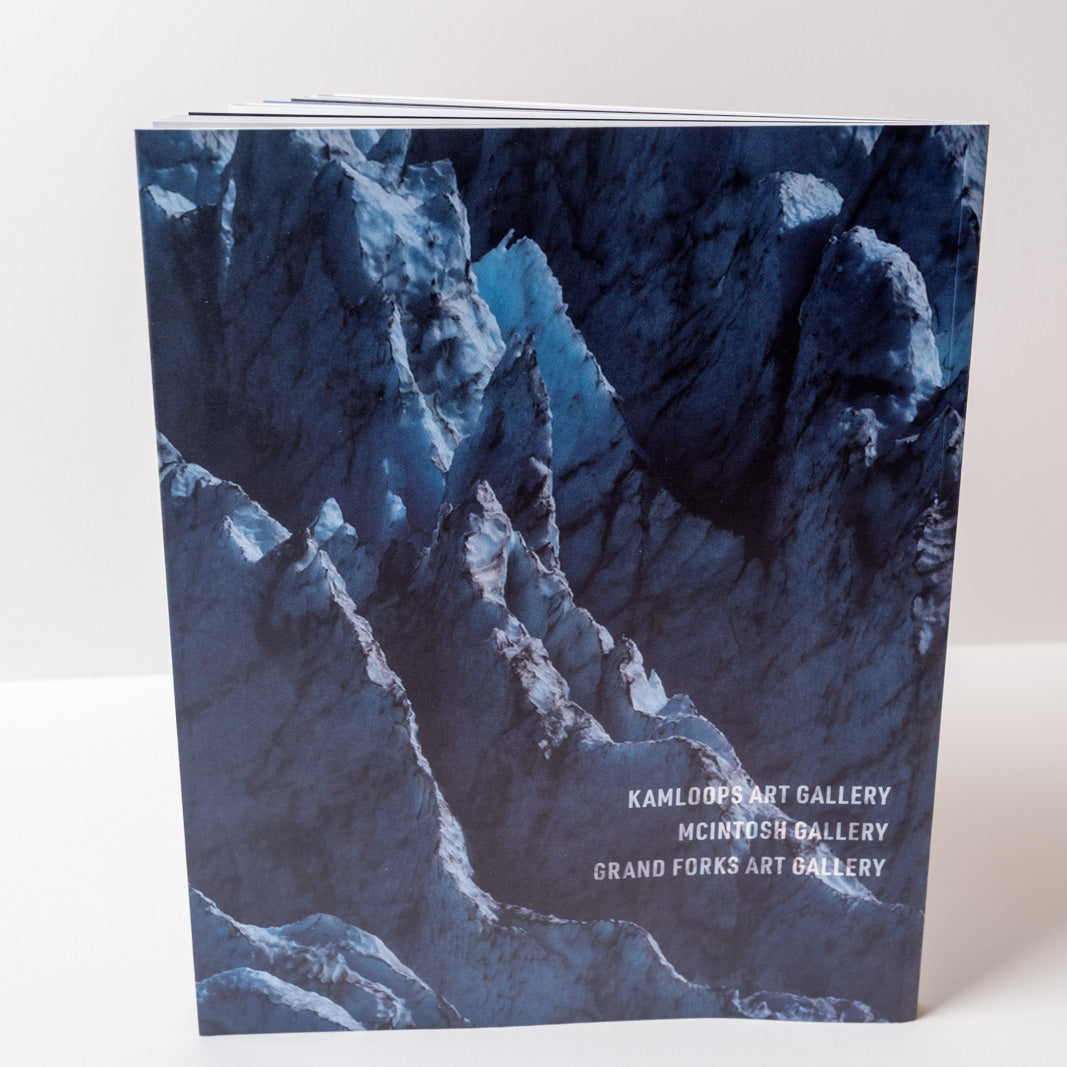 Book with a mountainous glacier landscape design on the cover, featuring 'Kamloops Art Gallery' text.