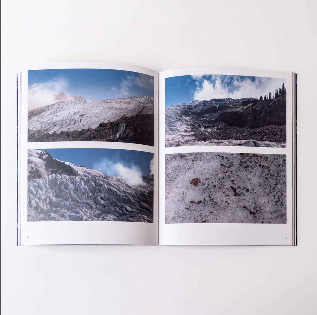 Open book showing images of snowy mountain landscapes.