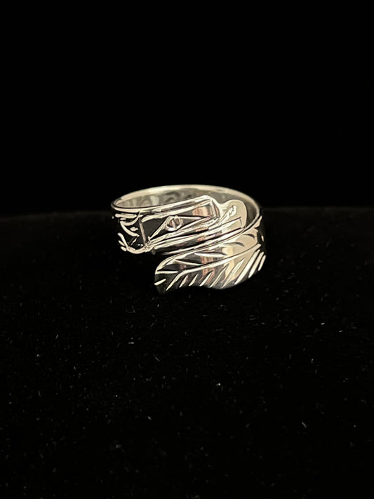 Silver ring with eagle design on a black background